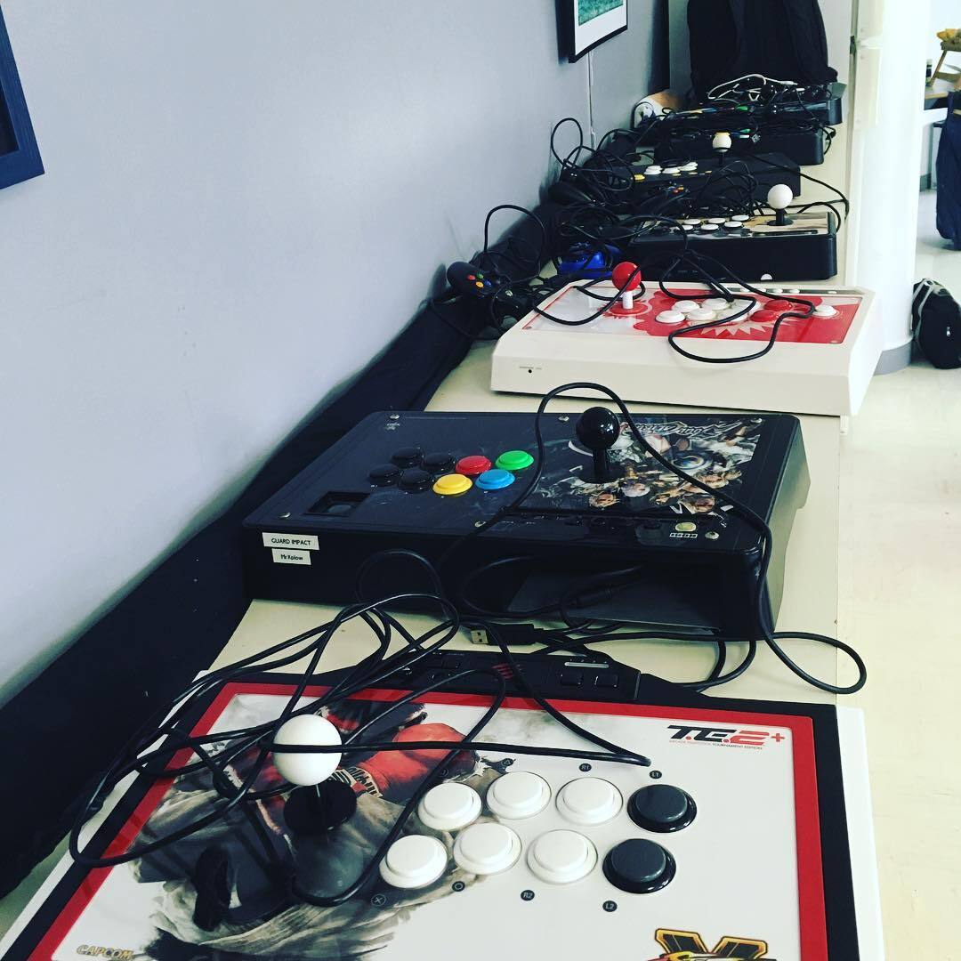 A bunch of arcade sticks on a table