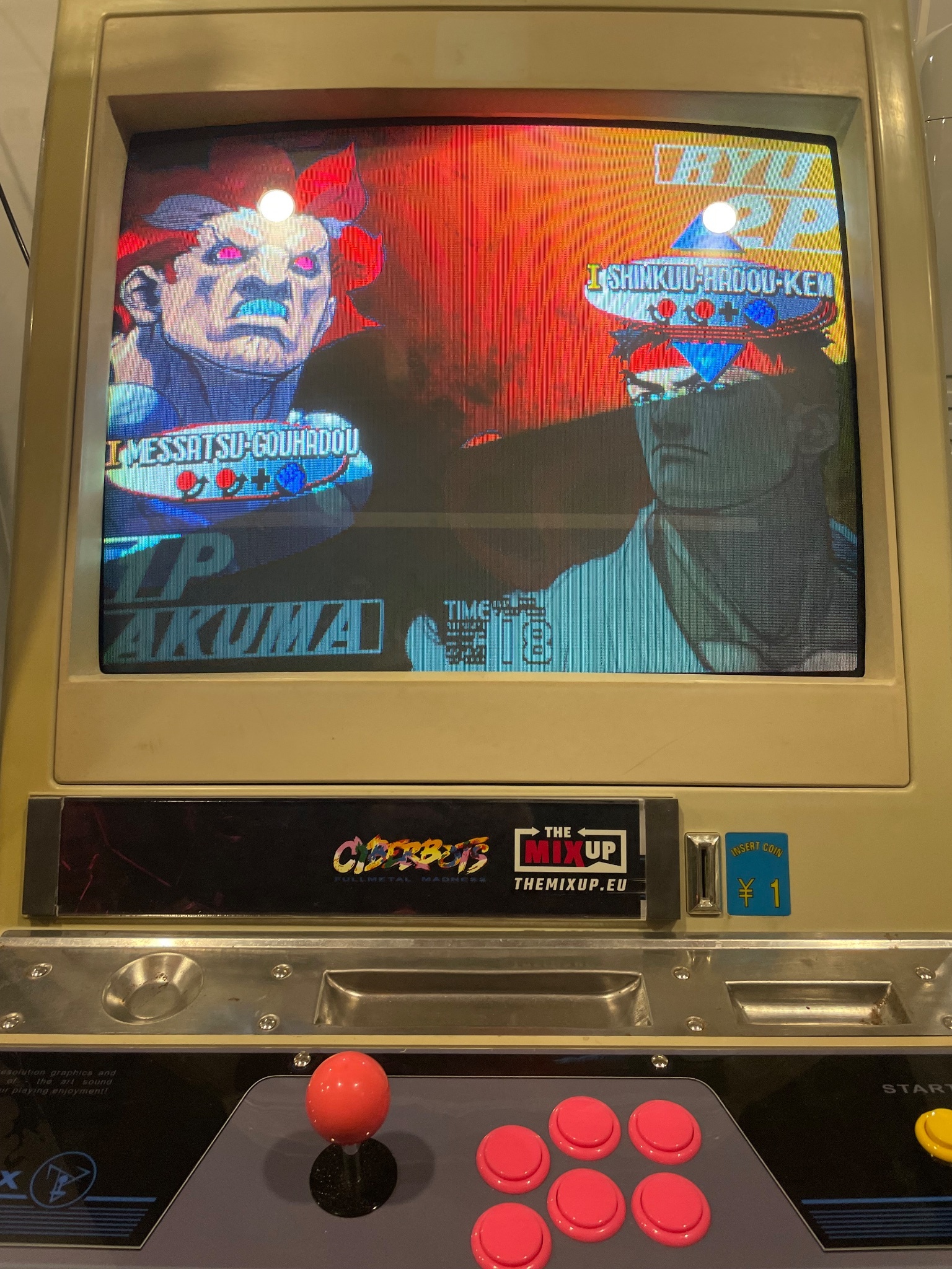 The screen of an arcade cab with Street Fighter playing.