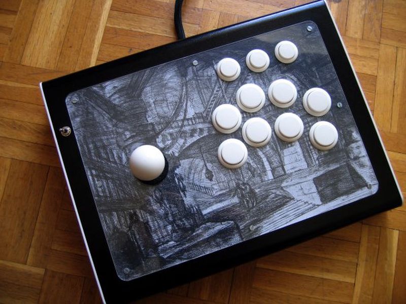A custom arcade stick with an art on it figcaption